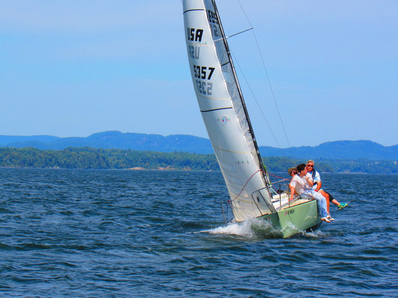 Sailboat heeling under wind on the lake