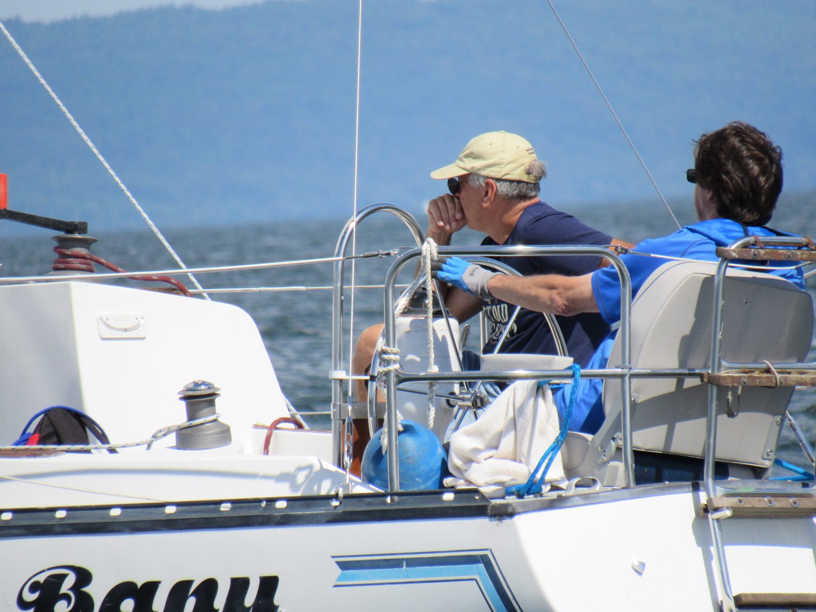 Skipper at the helm of a racing sailboat